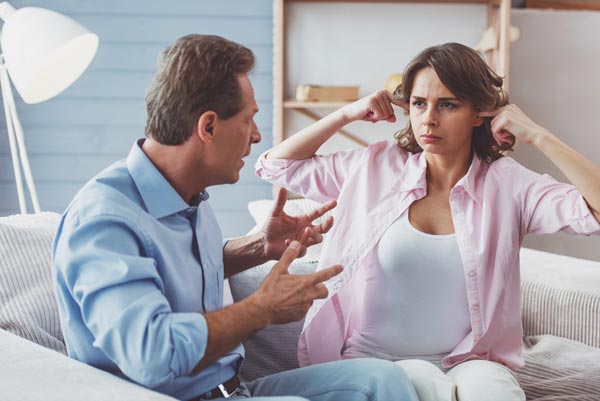 woman plugging her ears not listing to her husbands point of view