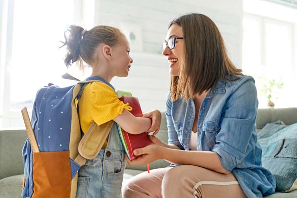 step parent and preschool child getting ready for school