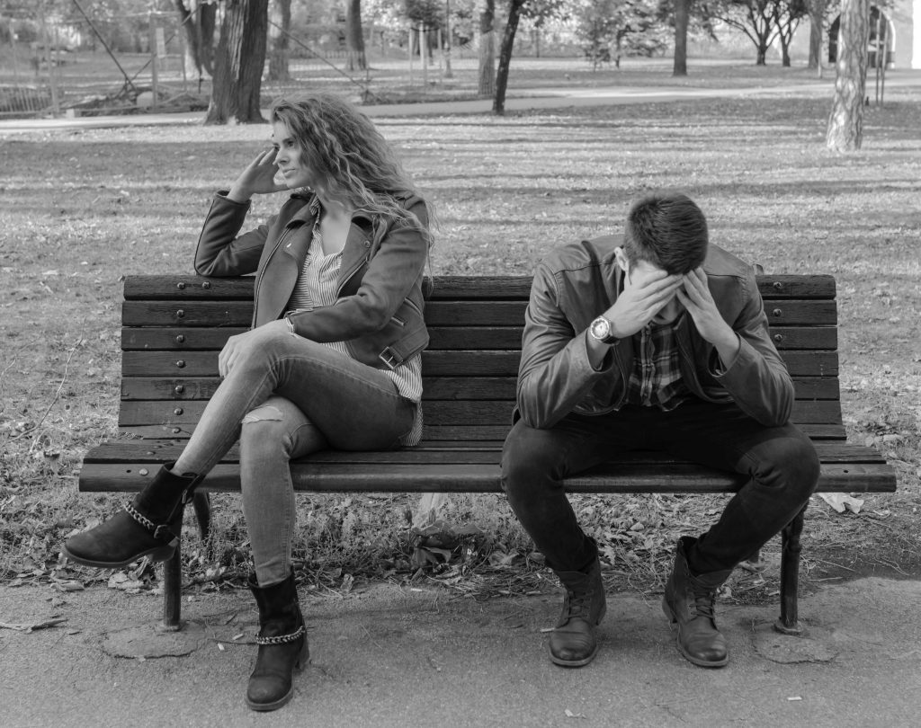 Attractive and handsome lovers trying to get over relationship crisis in the city park.